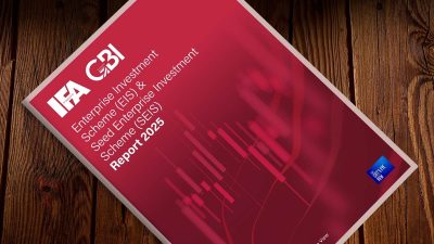 Physical copy of the EIS & SEIS report on a wooden background